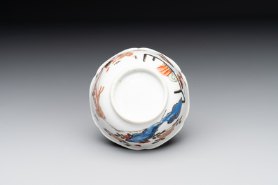 A Chinese polychrome cup and saucer with figures and a dog, Yongzheng