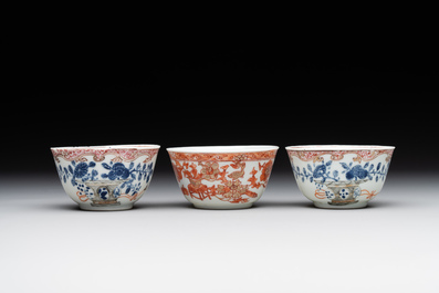 A pair of Chinese polychrome-decorated cups and saucers and an iron-red gilt-decorated cup and saucer, Yongzheng/Qianlong