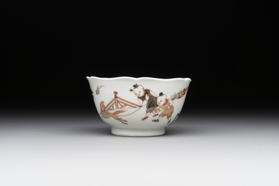 A Chinese polychrome cup and saucer with figures and a dog, Yongzheng
