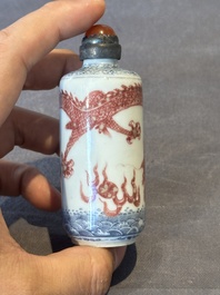 A Chinese blue, white and copper-red snuff bottle with a dragon, dragon mark, 19th C.