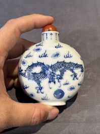 Three Chinese blue, white and copper-red snuff bottles and a blue and white snuff bottle, Qianlong mark, 19th C.