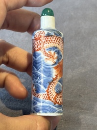 A Chinese blue and white 'figurative' snuff bottle and a blue, white and iron-red 'dragon' snuff bottle, Qianlong mark, 19th C.