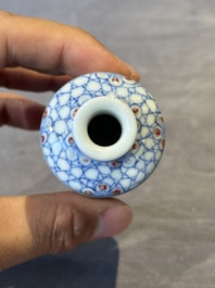 Four Chinese blue, white and copper-red snuff bottles and a blue and white snuff bottle, 19/20th C.