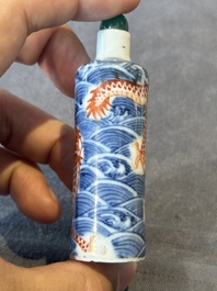 A Chinese blue and white 'figurative' snuff bottle and a blue, white and iron-red 'dragon' snuff bottle, Qianlong mark, 19th C.