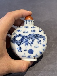 Three Chinese blue, white and copper-red snuff bottles and a blue and white snuff bottle, Qianlong mark, 19th C.