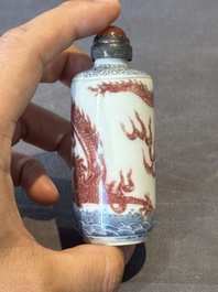 A Chinese blue, white and copper-red snuff bottle with a dragon, dragon mark, 19th C.