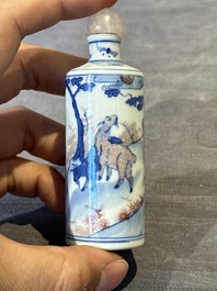 Four Chinese blue, white and copper-red snuff bottles and a blue and white snuff bottle, 19/20th C.