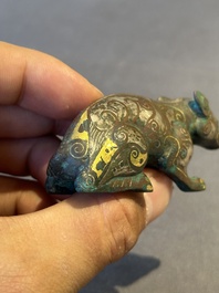 A rare Chinese gold and silver-inlaid bronze paperweight in the shape of a tapir '貘', Warring States period
