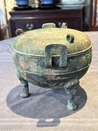 A Chinese archaic bronze tripod vessel and cover, 'ding 鼎', Eastern Zhou, Spring and Autumn period