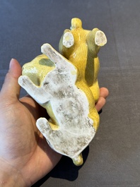 A Chinese monochrome yellow-glazed group of two playing dogs, 19th C.