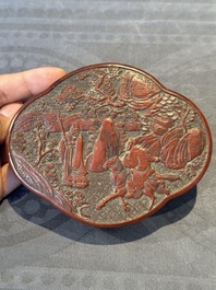 A Chinese quadrifoil red cinnabar lacquer box and cover with figural design, 19/20th C.