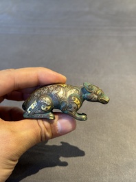 A rare Chinese gold and silver-inlaid bronze paperweight in the shape of a tapir '貘', Warring States period