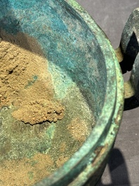 A Chinese archaic bronze tripod vessel and cover, 'ding 鼎', Eastern Zhou, Spring and Autumn period