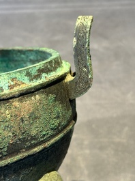 A Chinese archaic bronze tripod vessel and cover, 'ding 鼎', Eastern Zhou, Spring and Autumn period