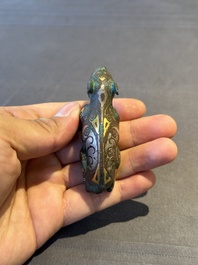 A rare Chinese gold and silver-inlaid bronze paperweight in the shape of a tapir '貘', Warring States period