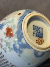 A Chinese famille rose cup with a boy and a rooster on wooden base, Qianlong mark, 20th C.