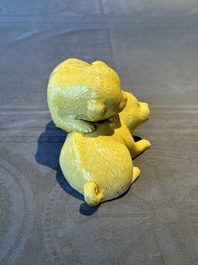 A Chinese monochrome yellow-glazed group of two playing dogs, 19th C.