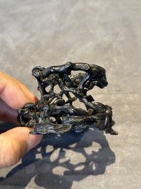 A Chinese famille rose cup with a boy and a rooster on wooden base, Qianlong mark, 20th C.