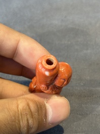 A Chinese carved red coral 'boy and vase' snuff bottle and stopper, 19th C.