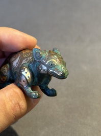 A rare Chinese gold and silver-inlaid bronze paperweight in the shape of a tapir '貘', Warring States period