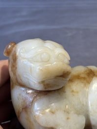 A large Chinese white and russet jade sculpture of a mythical beast, 17/18th C.