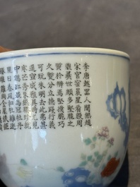 A Chinese famille rose cup with a boy and a rooster on wooden base, Qianlong mark, 20th C.