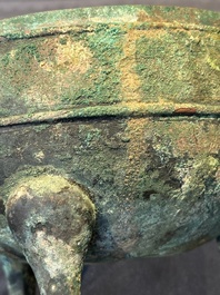 A Chinese archaic bronze tripod vessel and cover, 'ding 鼎', Eastern Zhou, Spring and Autumn period