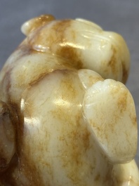 A large Chinese white and russet jade sculpture of a mythical beast, 17/18th C.