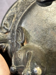 A Chinese bronze 'elephant' tripod censer and cover, Ming