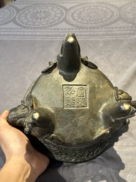 A Chinese bronze 'elephant' tripod censer and cover, Ming