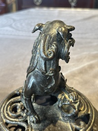 A large Chinese bronze censer and cover with a Buddhist lion, Ming