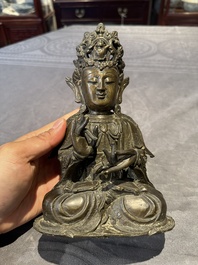 A Chinese bronze Guanyin, Ming and a Tibetan polychrome plaster relief, 19th C.