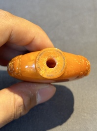 A rare Chinese amber snuff bottle with lion handles, 19th C.