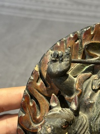 A Chinese bronze Guanyin, Ming and a Tibetan polychrome plaster relief, 19th C.