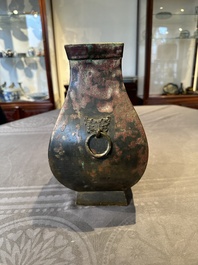 A Chinese archaic bronze vase with 'Taotie' handles, 'fang hu 方壺', Han