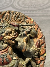 A Chinese bronze Guanyin, Ming and a Tibetan polychrome plaster relief, 19th C.