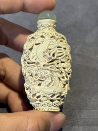 A Chinese moulded cream-glazed 'dragon and phoenix' snuff bottle, Jiaqing mark, 19th C.