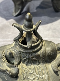 A Chinese bronze 'elephant' tripod censer and cover, Ming