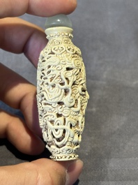 A Chinese moulded cream-glazed 'dragon and phoenix' snuff bottle, Jiaqing mark, 19th C.