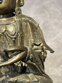 A Chinese bronze Guanyin, Ming and a Tibetan polychrome plaster relief, 19th C.