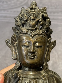 A Chinese bronze Guanyin, Ming and a Tibetan polychrome plaster relief, 19th C.