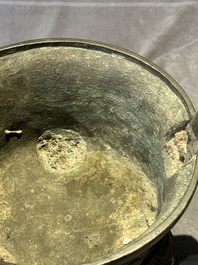A Chinese bronze 'elephant' tripod censer and cover, Ming
