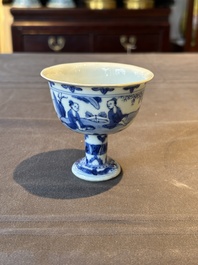 A Chinese blue and white stem cup with scholars in a landscape, Transitional period