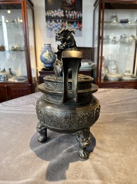A large Chinese bronze censer and cover with a Buddhist lion, Ming