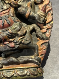 A Chinese bronze Guanyin, Ming and a Tibetan polychrome plaster relief, 19th C.