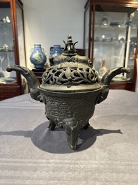 A Chinese bronze 'elephant' tripod censer and cover, Ming