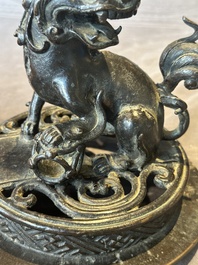A large Chinese bronze censer and cover with a Buddhist lion, Ming