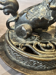 A large Chinese bronze censer and cover with a Buddhist lion, Ming