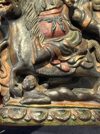 A Chinese bronze Guanyin, Ming and a Tibetan polychrome plaster relief, 19th C.