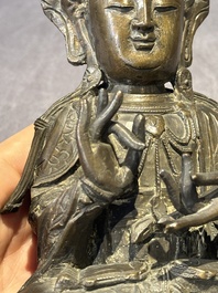 A Chinese bronze Guanyin, Ming and a Tibetan polychrome plaster relief, 19th C.